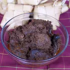 Rendang beef dry curry on a plate, dark brown and caramelised, served with rice