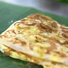 Roti canai flatbread with dhal curry and sambal on the side